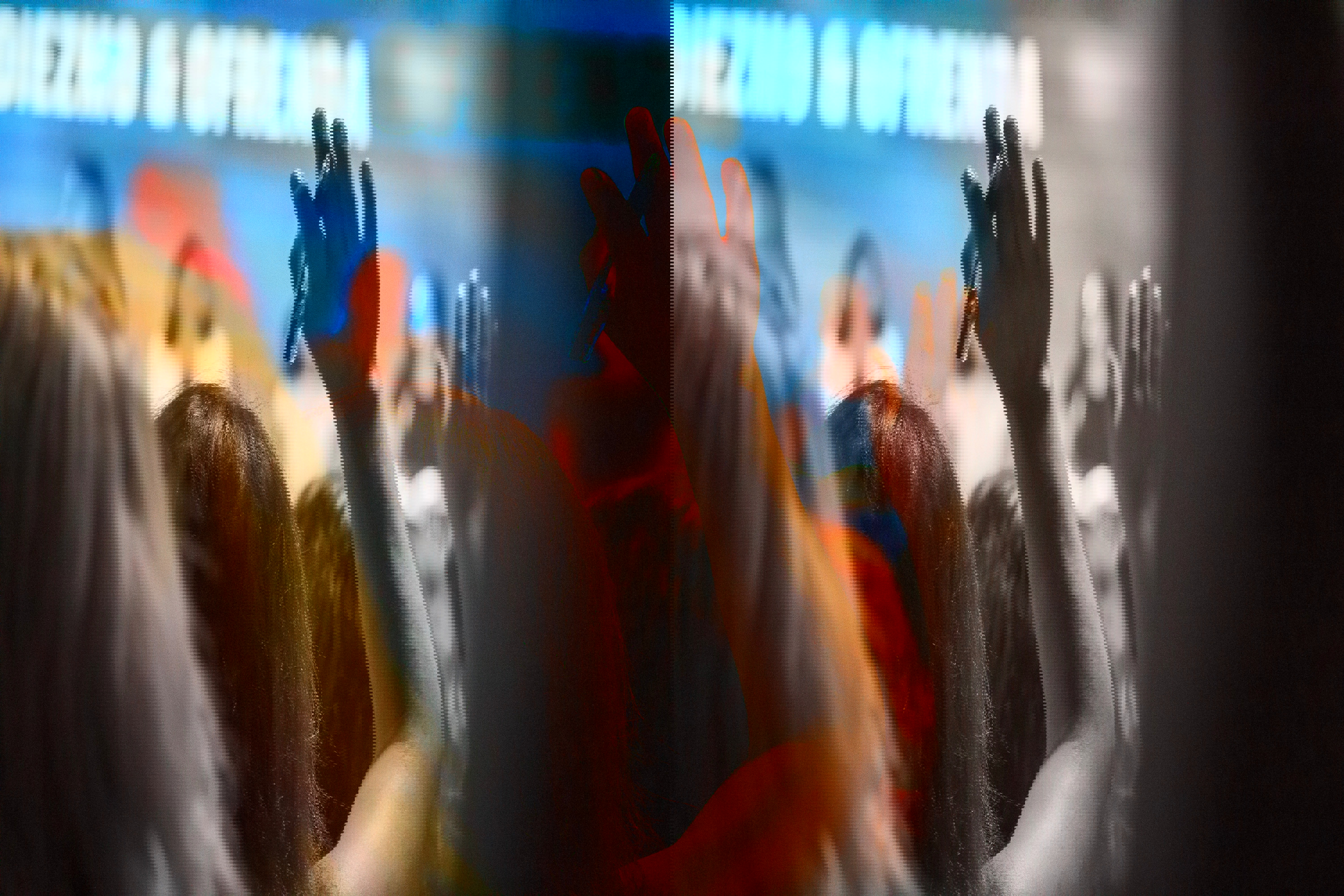 A person raises their hand at a seminar. 