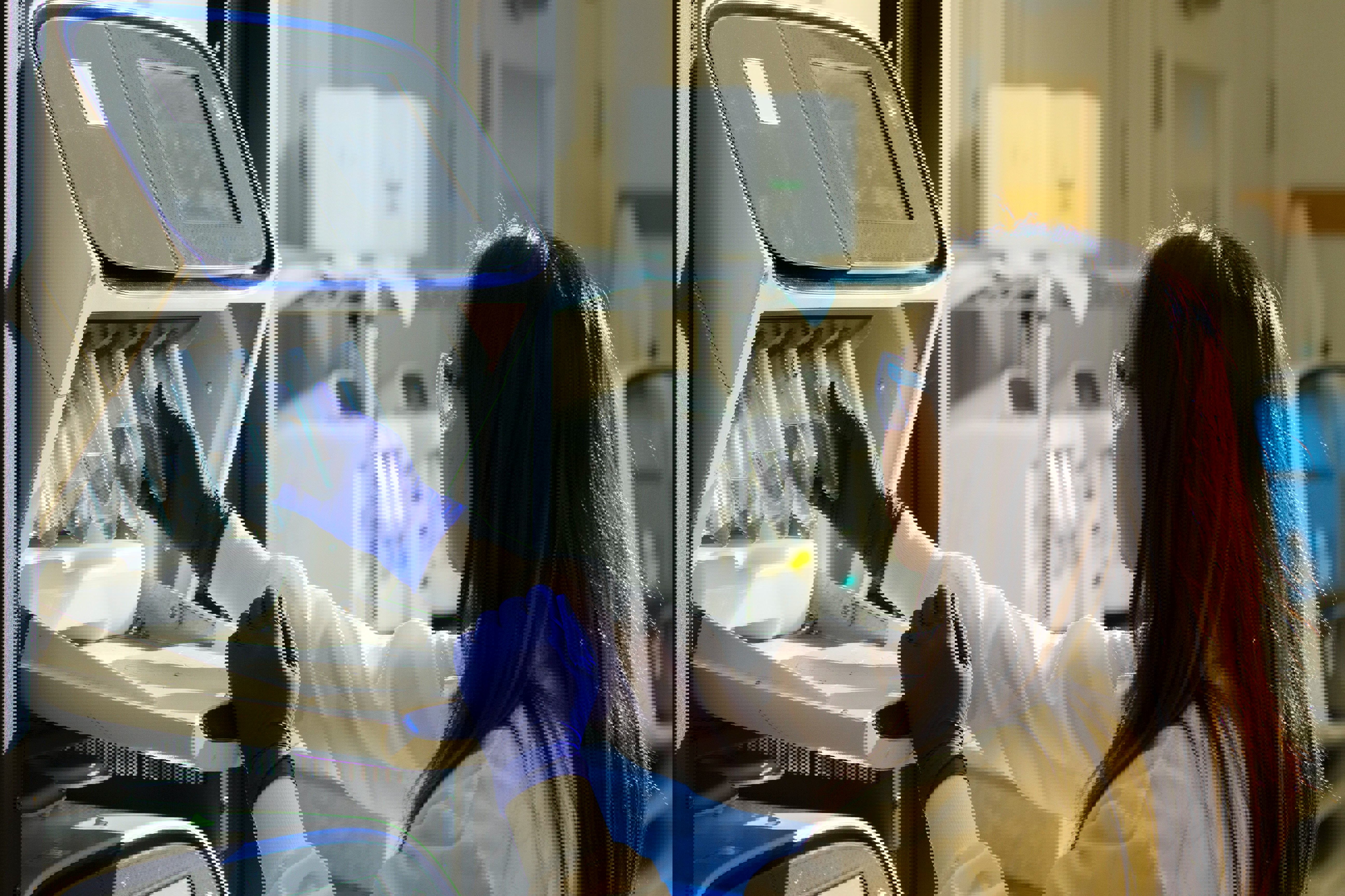Young woman working with gloves in lab environment